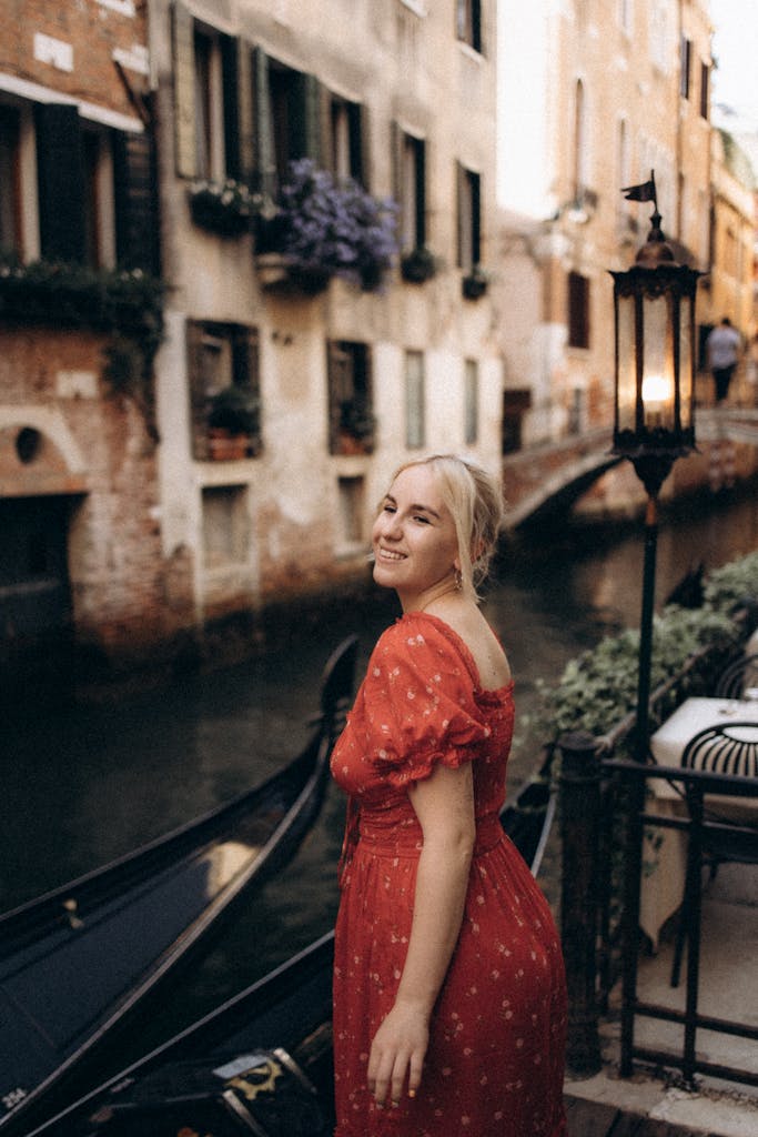 A serene woman stands by the iconic canals of Venice, Italy.
