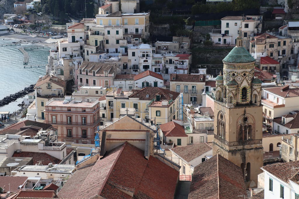 Aerial shot of a quaint coastal town with historic architecture and scenic waterfront.