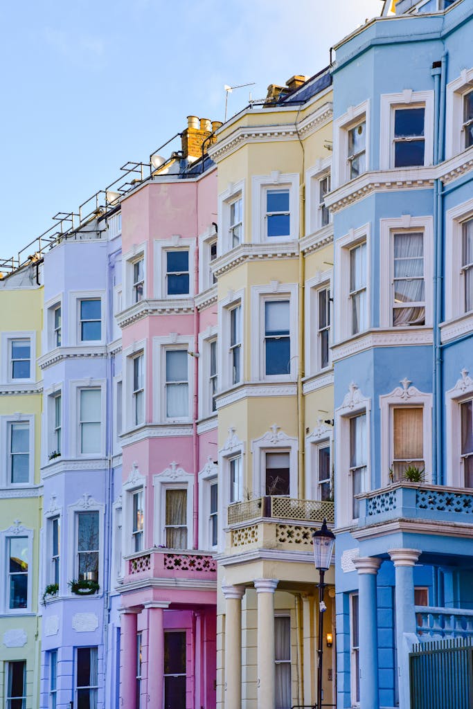 Colorful townhouses in London's Notting Hill, showcasing iconic urban charm.