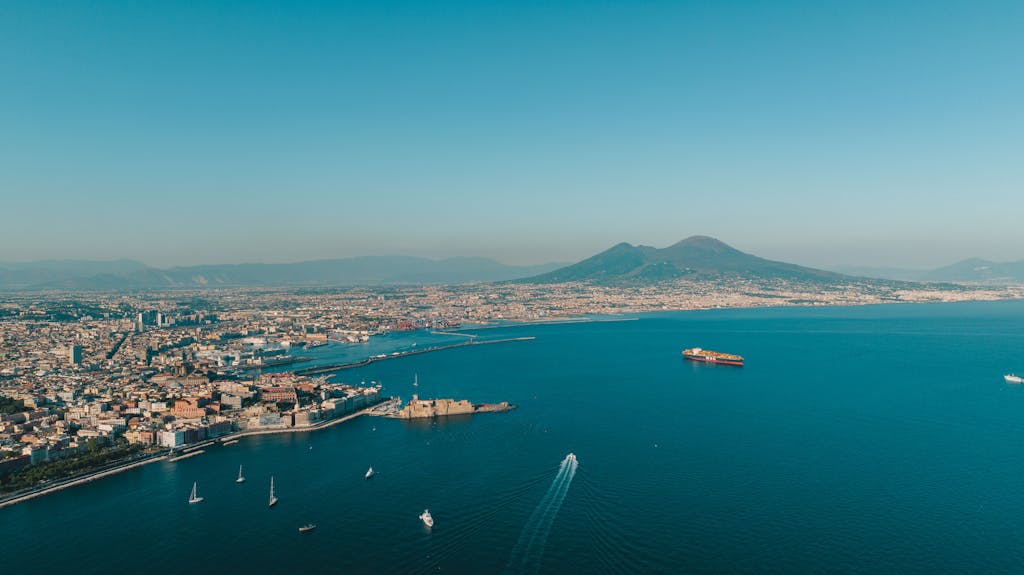 Stunning aerial view of Naples coastline with Mount Vesuvius in the background.