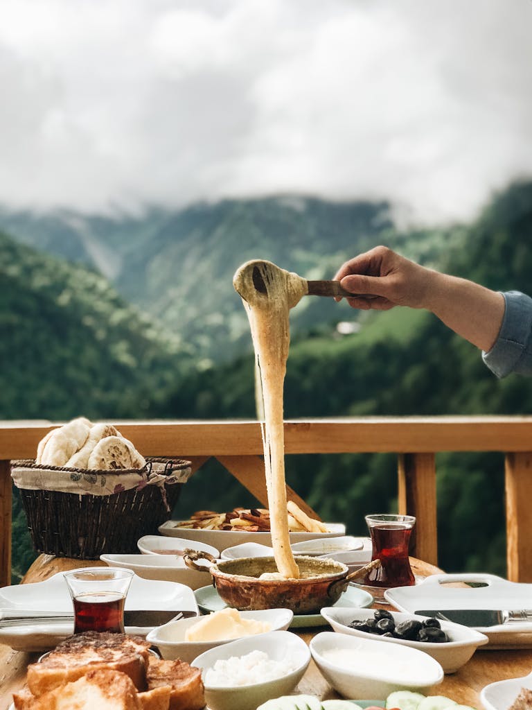 Enjoying a delicious cheese fondue with a breathtaking mountain view.