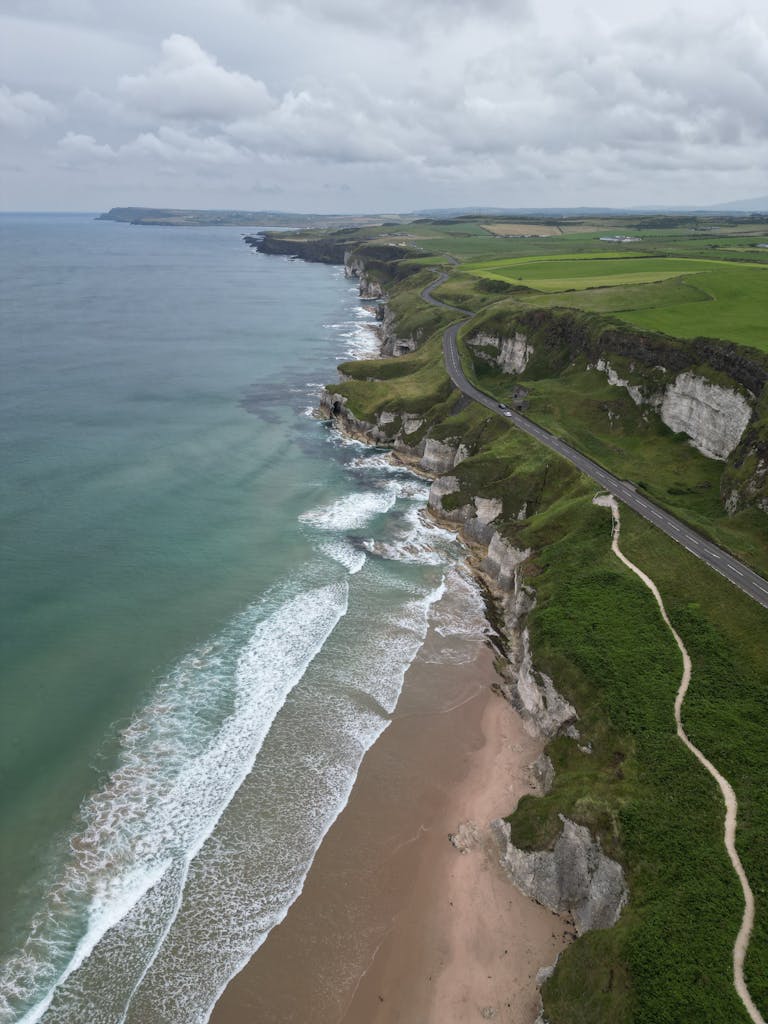 A breathtaking aerial view of Northern Ireland's rugged coastline and lush landscape.