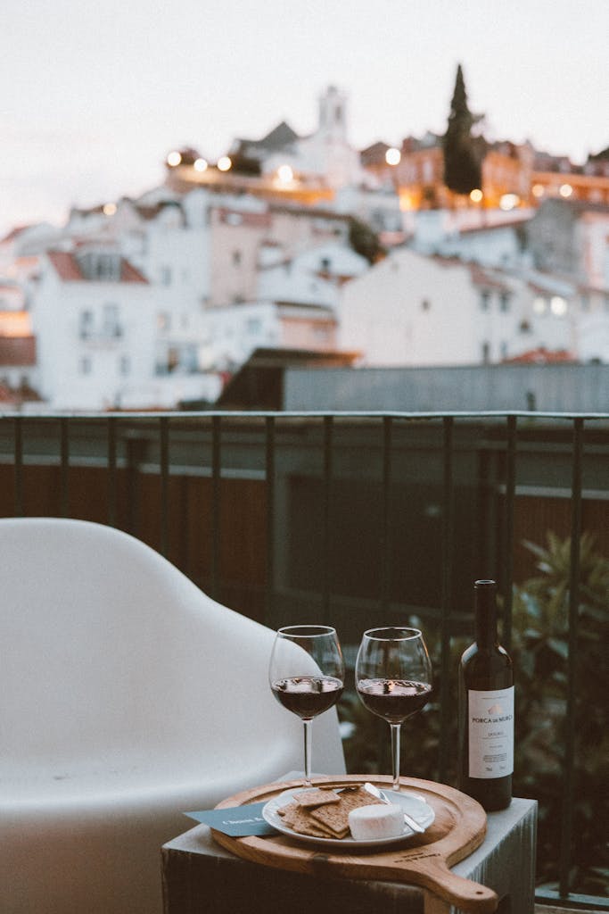 Enjoy a romantic evening in Lisbon with wine and cheese on a cozy rooftop setting.