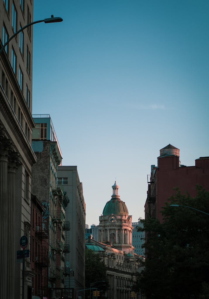 Urban scene featuring a landmark architecture and city skyline at dusk.