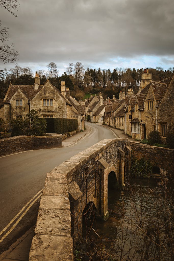 Quaint stone cottages and a bridge in the scenic Cotswolds village, England.