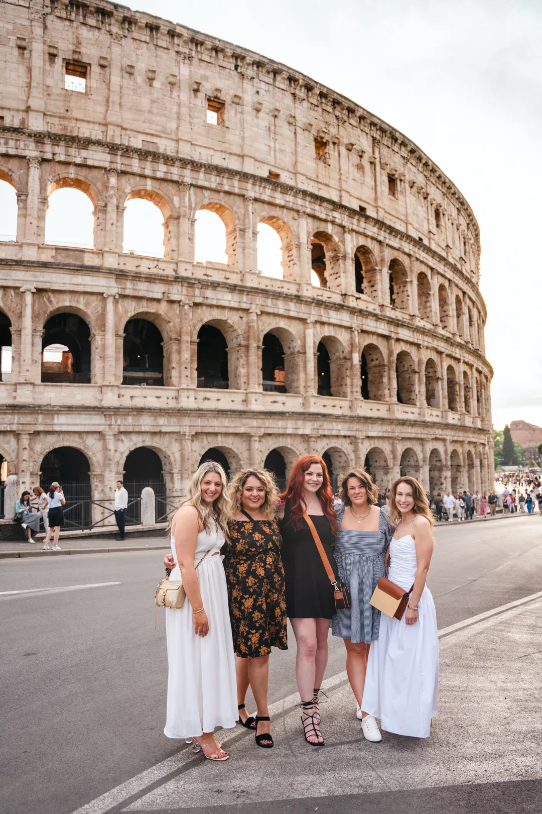 group of women in front of the roman colosseum