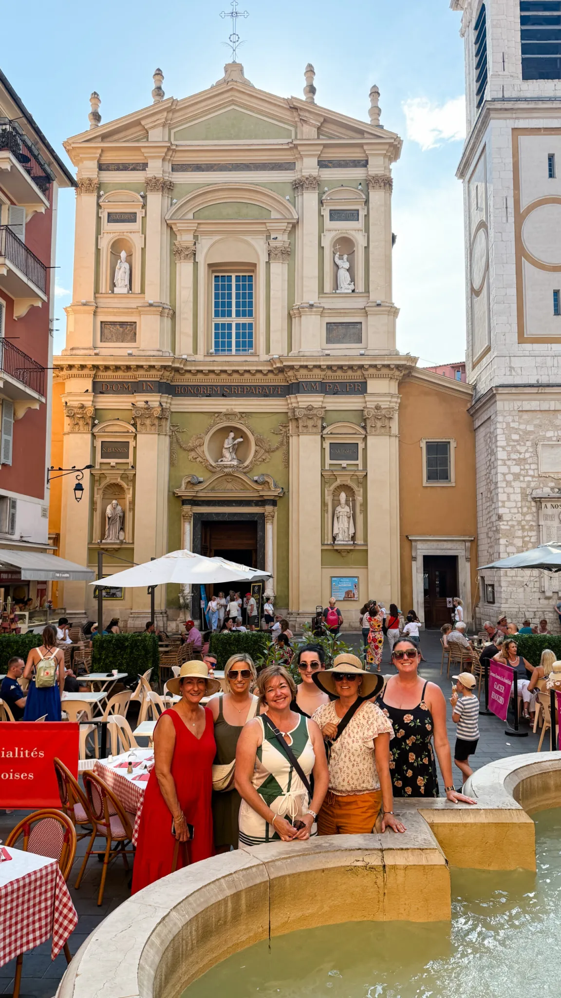 group photo of girls standing next to a fountain in italy