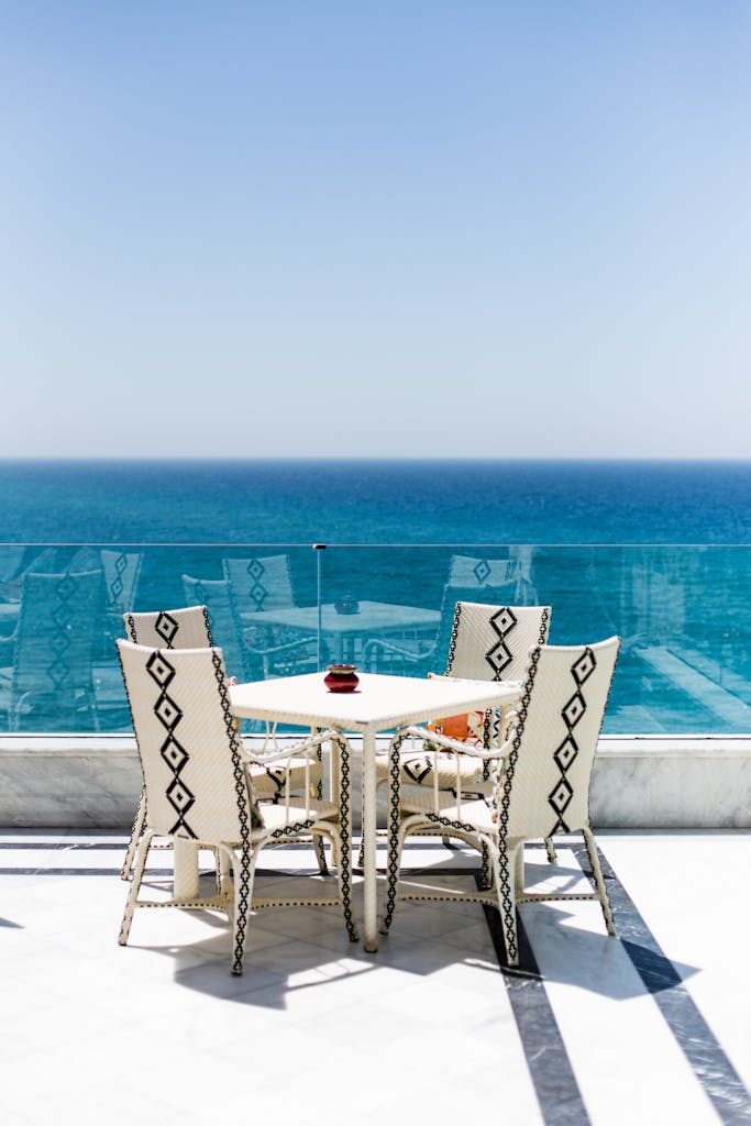 Elegant outdoor seating area on a terrace overlooking the ocean in Tangier, Morocco.
