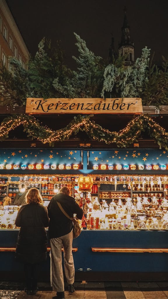 Explore the enchanting atmosphere of Munich's Christmas market at night, featuring bright lights and festive stalls.