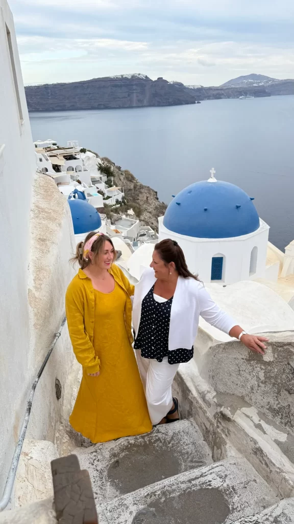 two women on stone stairs in greece