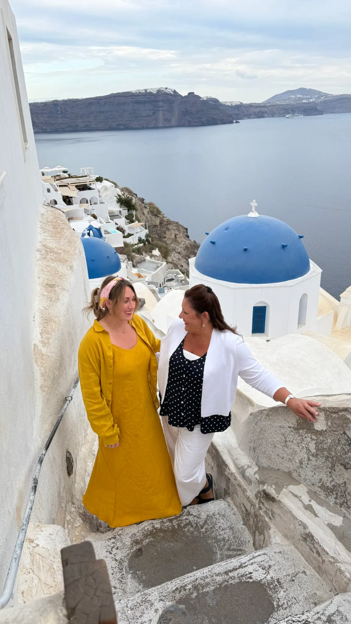 two women on stone stairs in greece