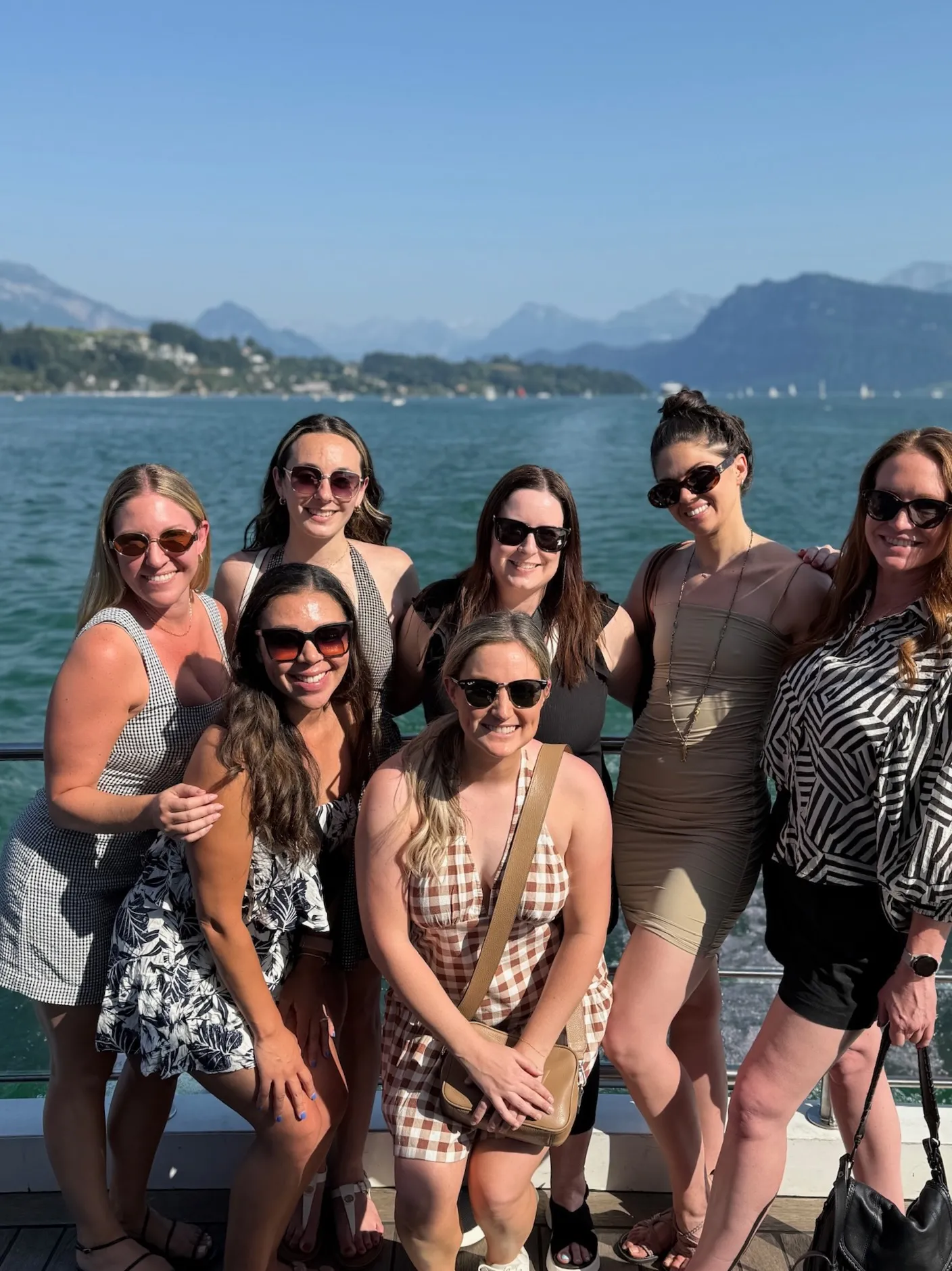 group of women in front of a lake