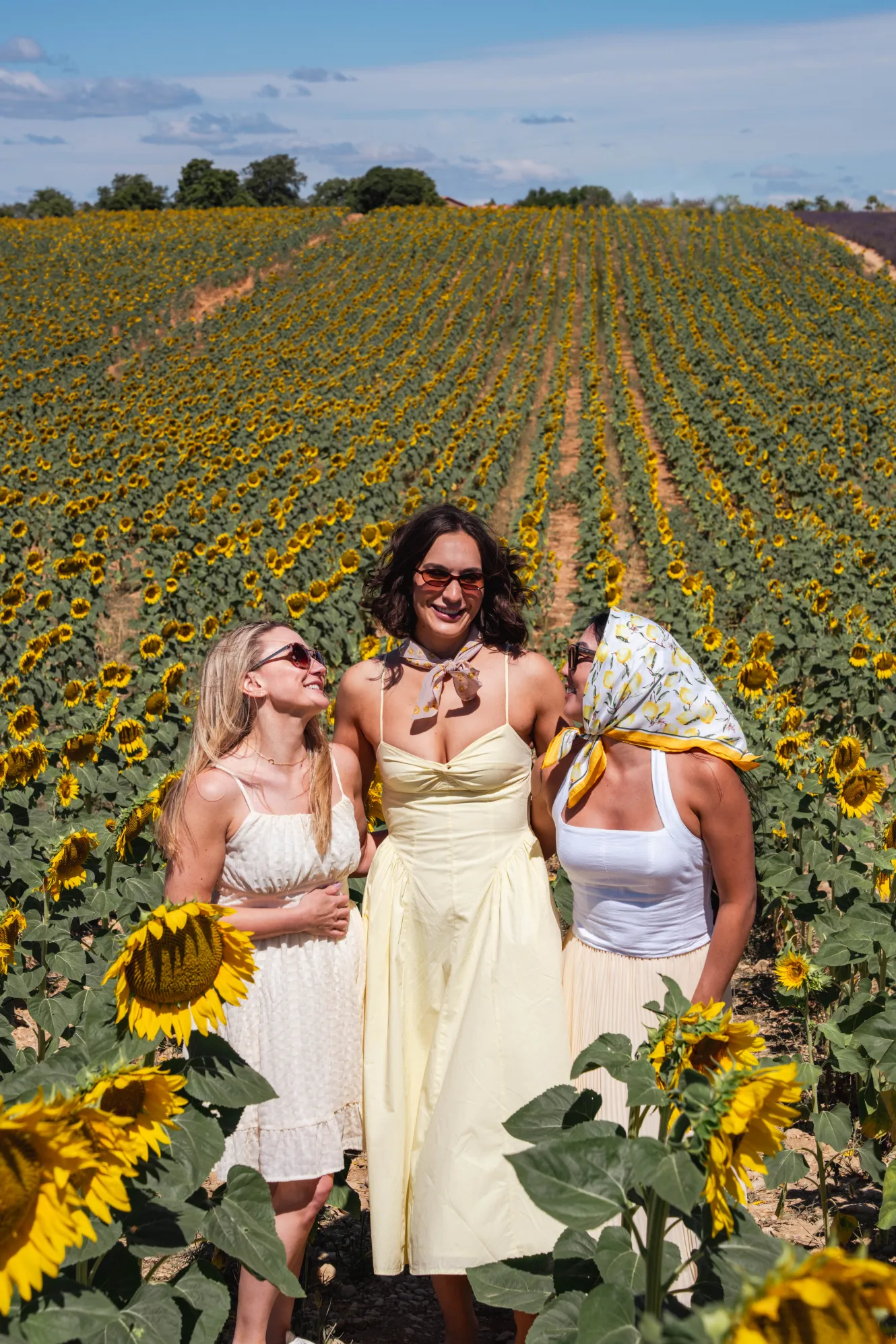 group of women in a sunflower field