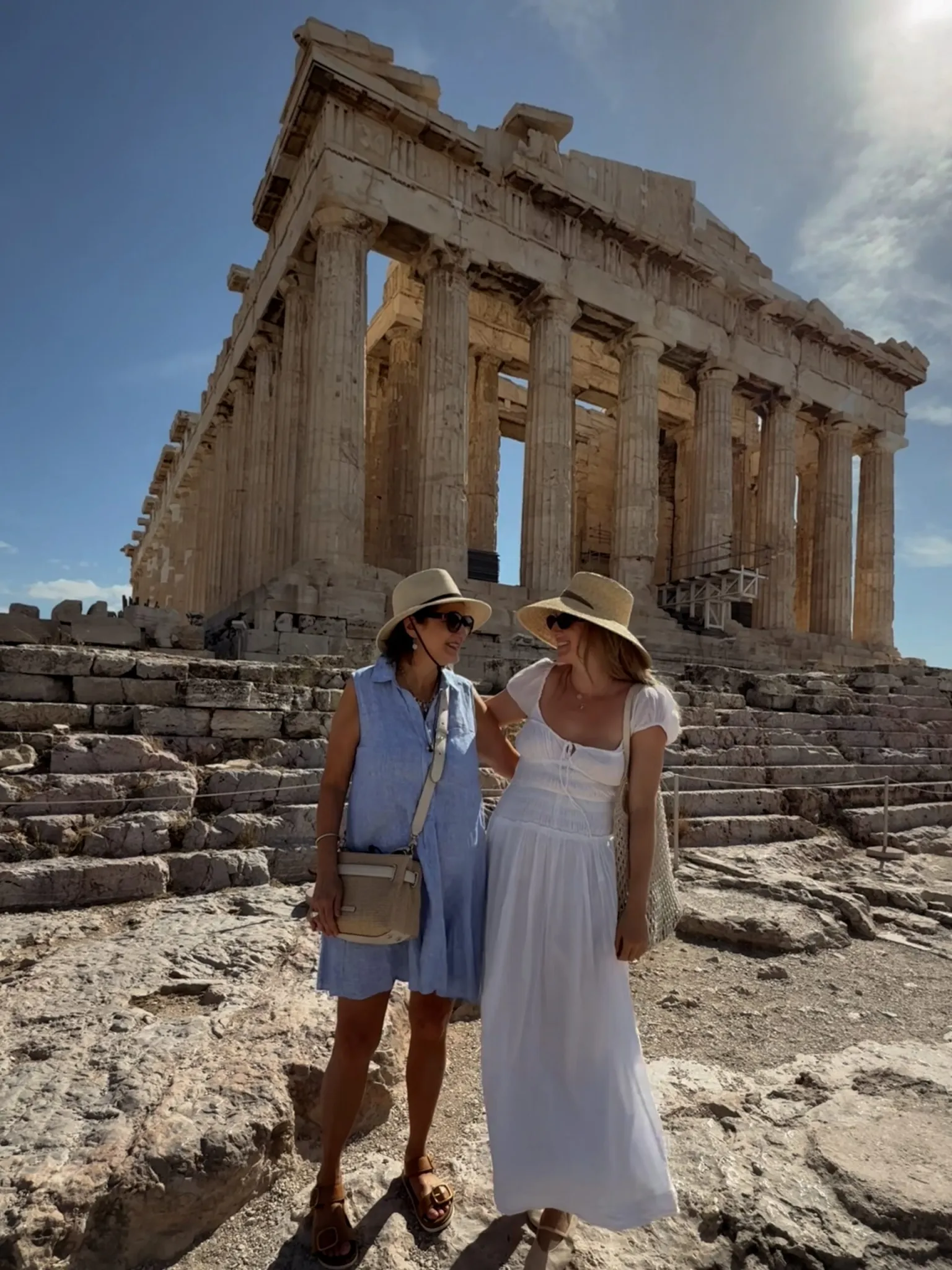 two women in front of a colonial roman building
