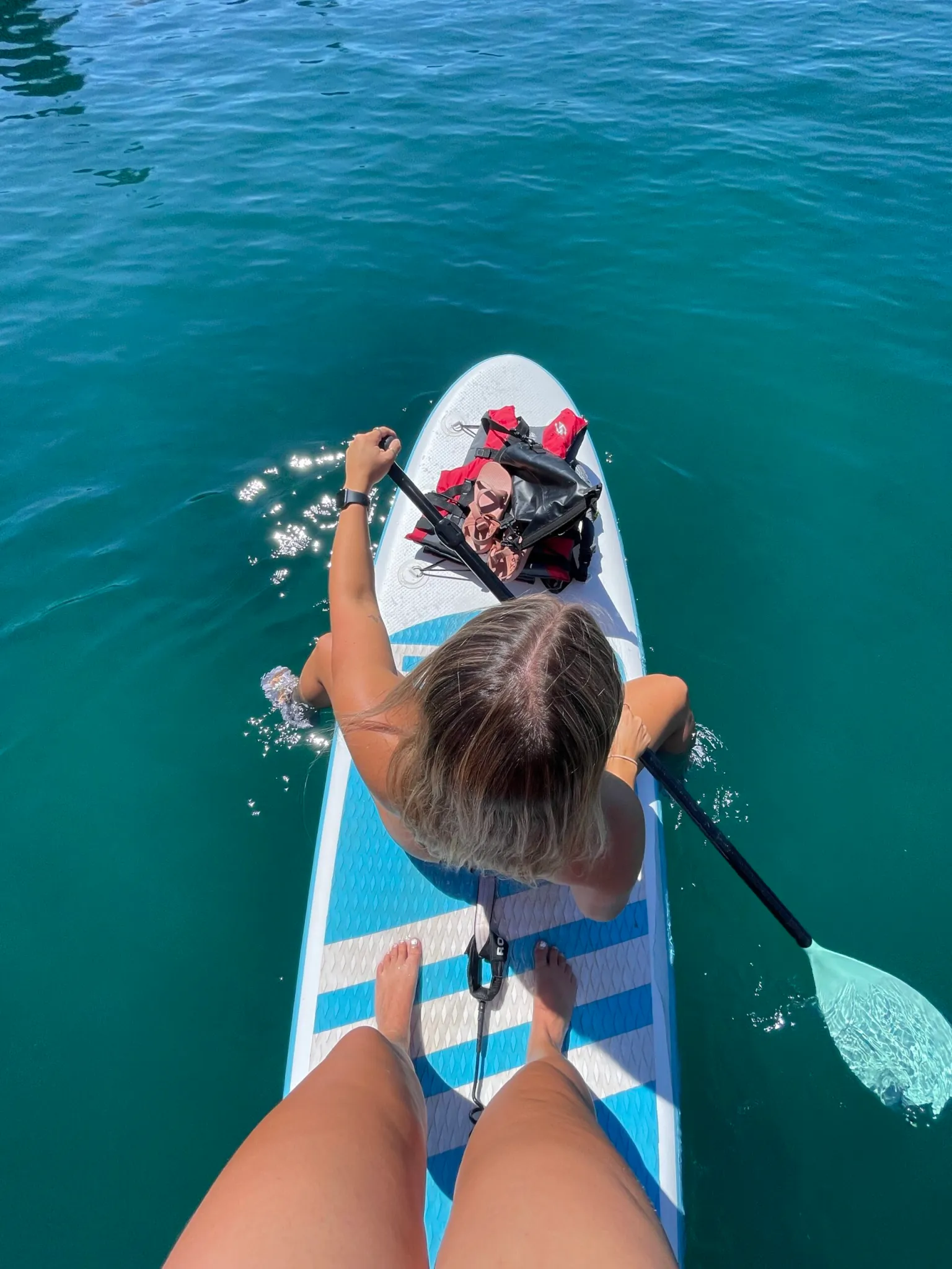 woman on a paddle boat in blue water