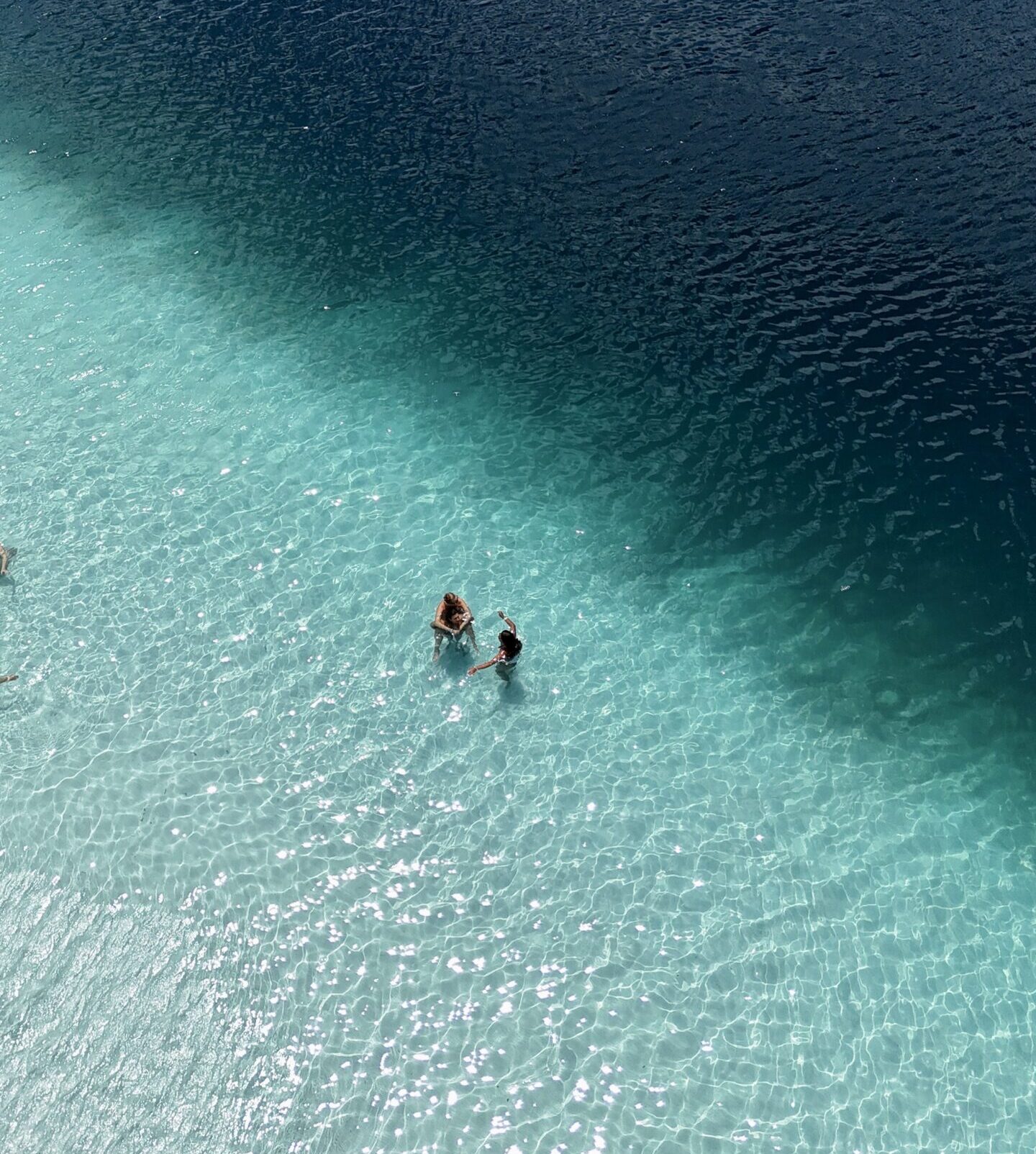 aerial shot of two people in an ocean