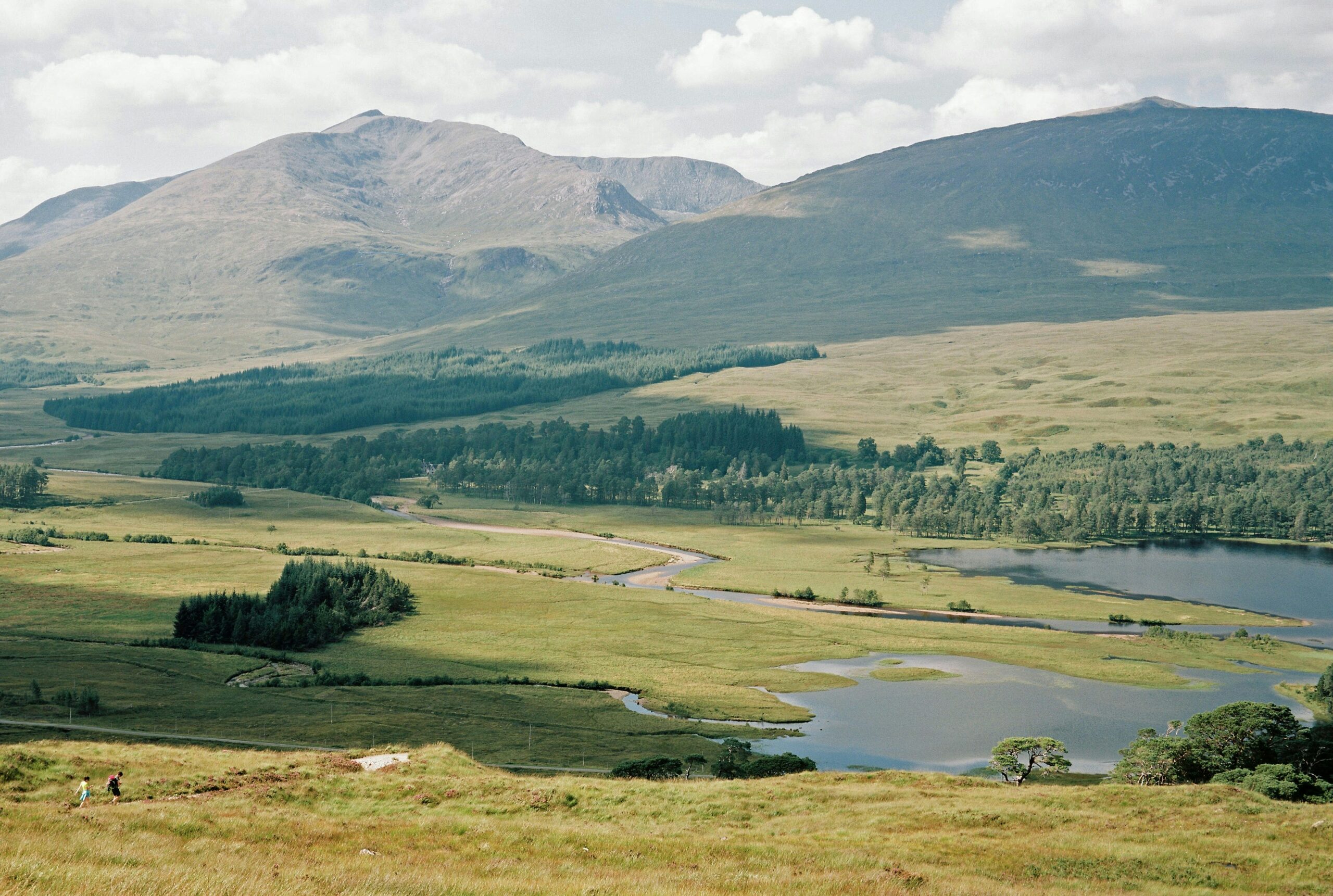 scenic green landscape view of lakes surrounded by mountains