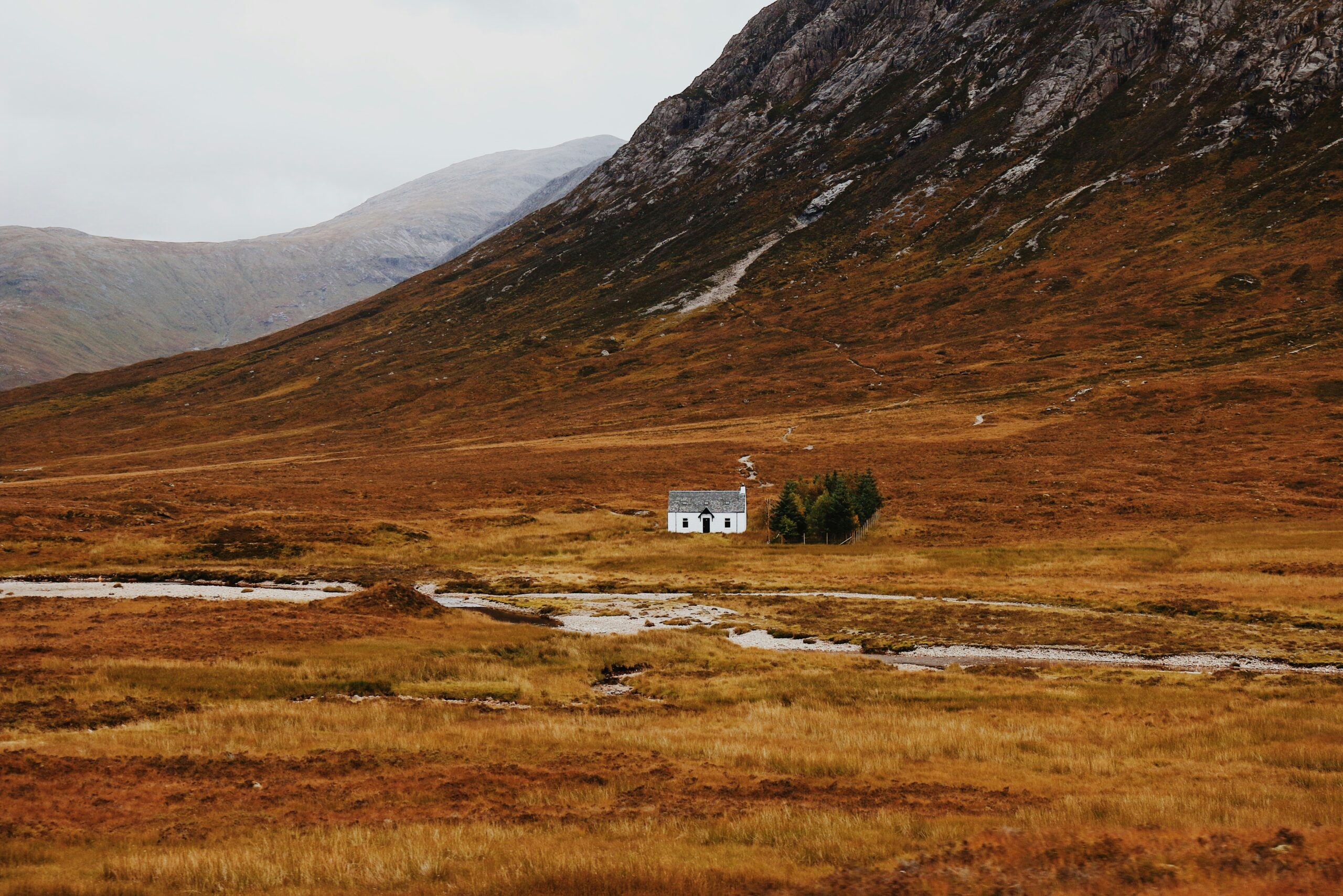 isolated white house surrounded by rocky mountains